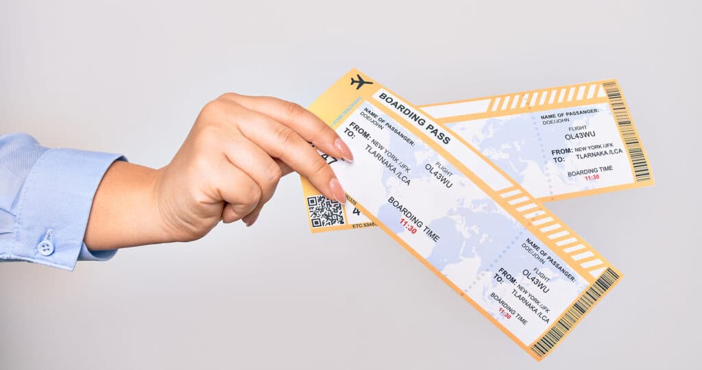 Hand of caucasian young woman holding boarding pass airlane over